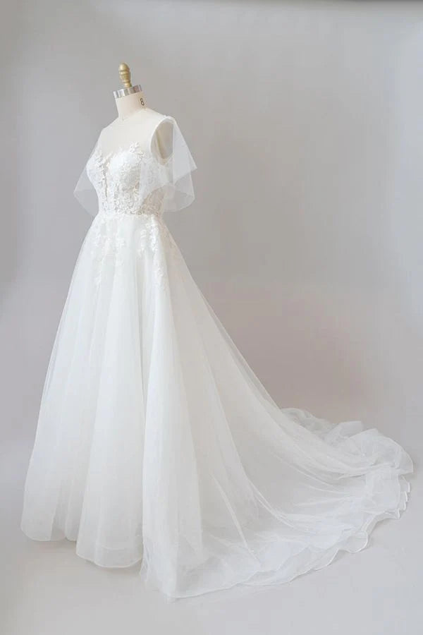 Side view of A-line V-neck wedding dress with flowing tulle skirt.