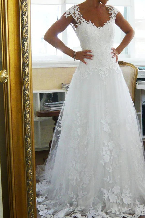 Elegant A-line V-neck lace wedding dress with a long train.
