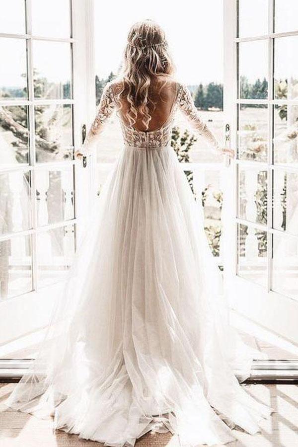 Back view of an elegant ivory tulle wedding gown with sheer details.