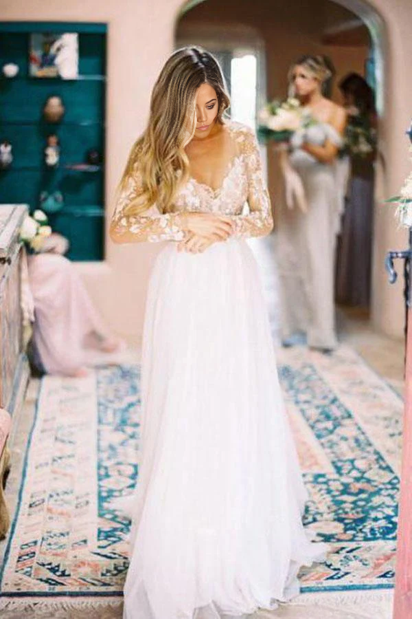 Close-up of the long sleeve and delicate tulle fabric on an A-line wedding dress.