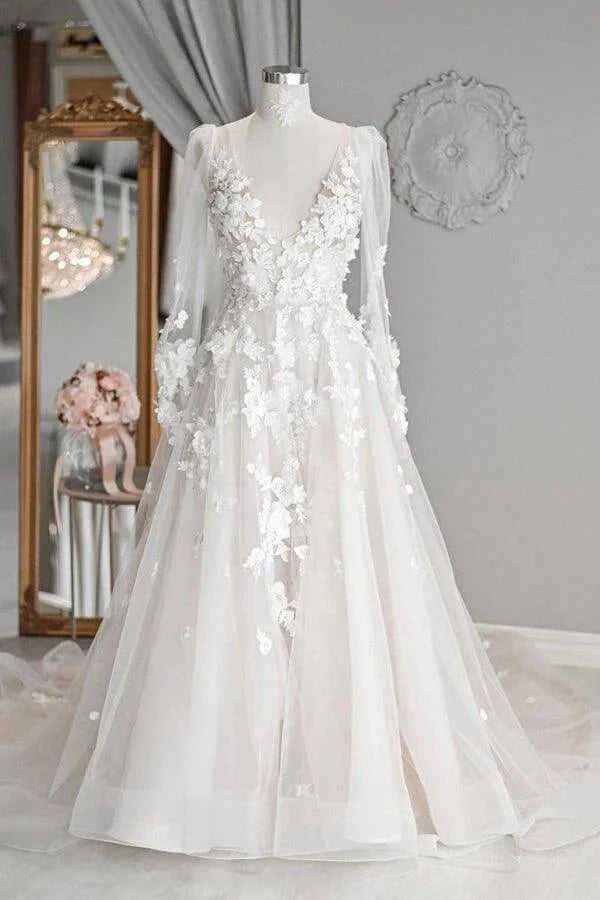 Elegant ivory A-line tulle wedding dress with V-neck, long sleeves, and court train.