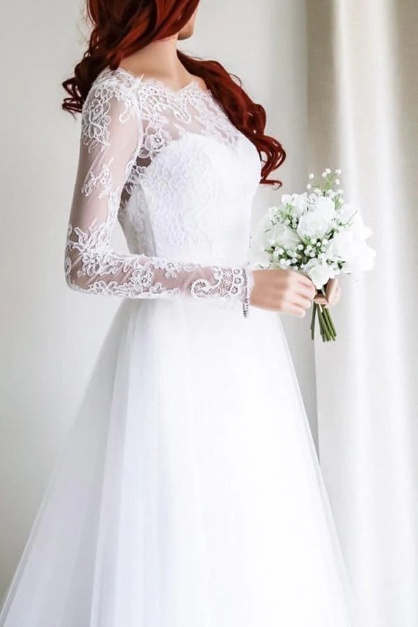 Intricate lace detail on the white long sleeve wedding dress.