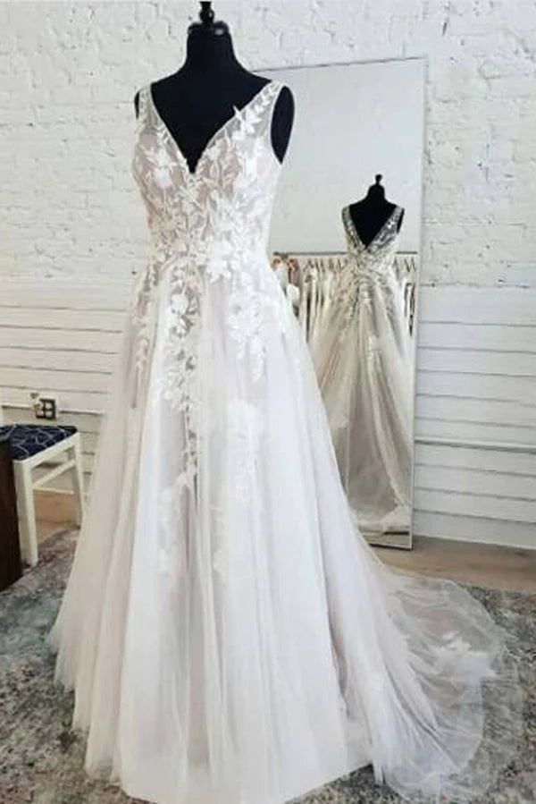 Elegant A-line wedding dress with V-neck, lace bodice, and flowing tulle skirt.