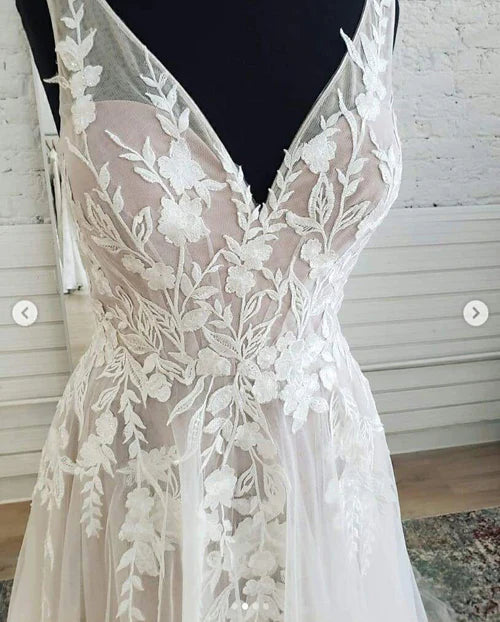Close-up of the delicate lace detailing on the V-neck A-line wedding dress.