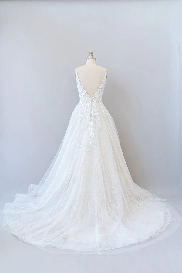Side view of A-line wedding dress showing tulle skirt and lace details.