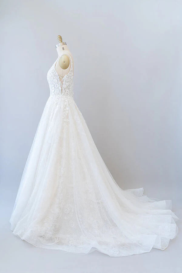 Back view of wedding dress highlighting the open back design and appliques.