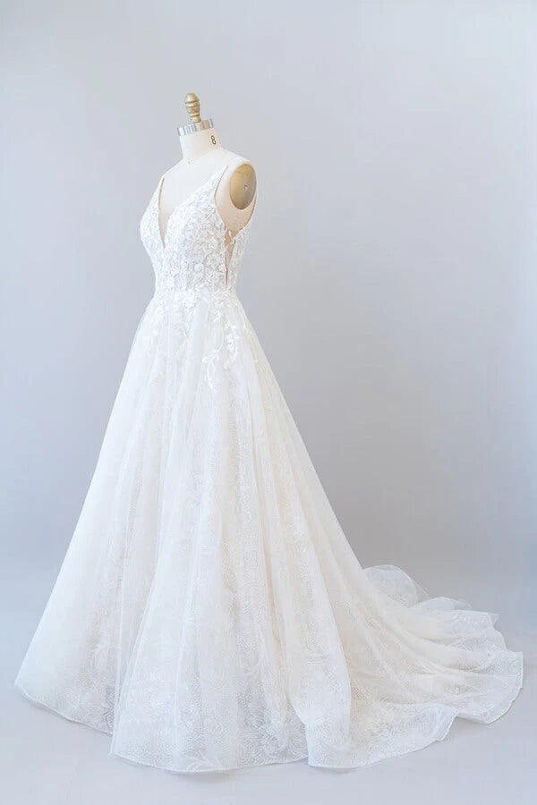 Close-up of lace appliques and tulle fabric on wedding dress.