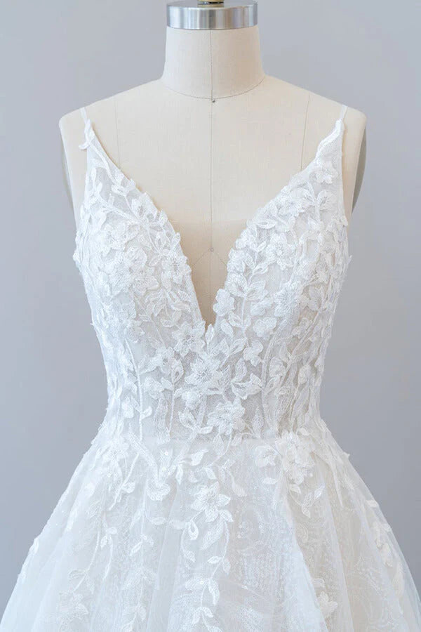 Full length view of elegant A-line V-neck wedding gown.