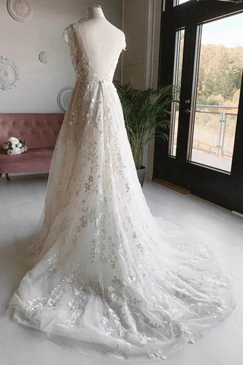 Close-up of delicate lace flower embellishments on a tulle wedding dress.