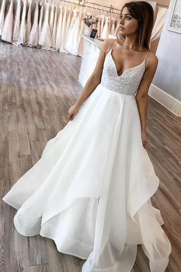 Elegant A-line V-neck organza wedding dress with spaghetti straps.