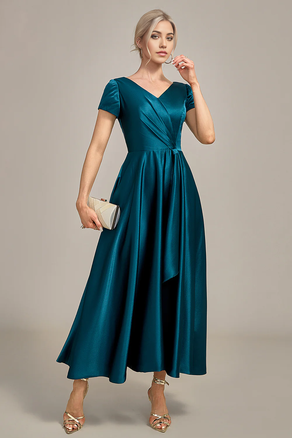Woman wearing a peacock blue A-line V-neck pleated satin Mother of the Bride dress.