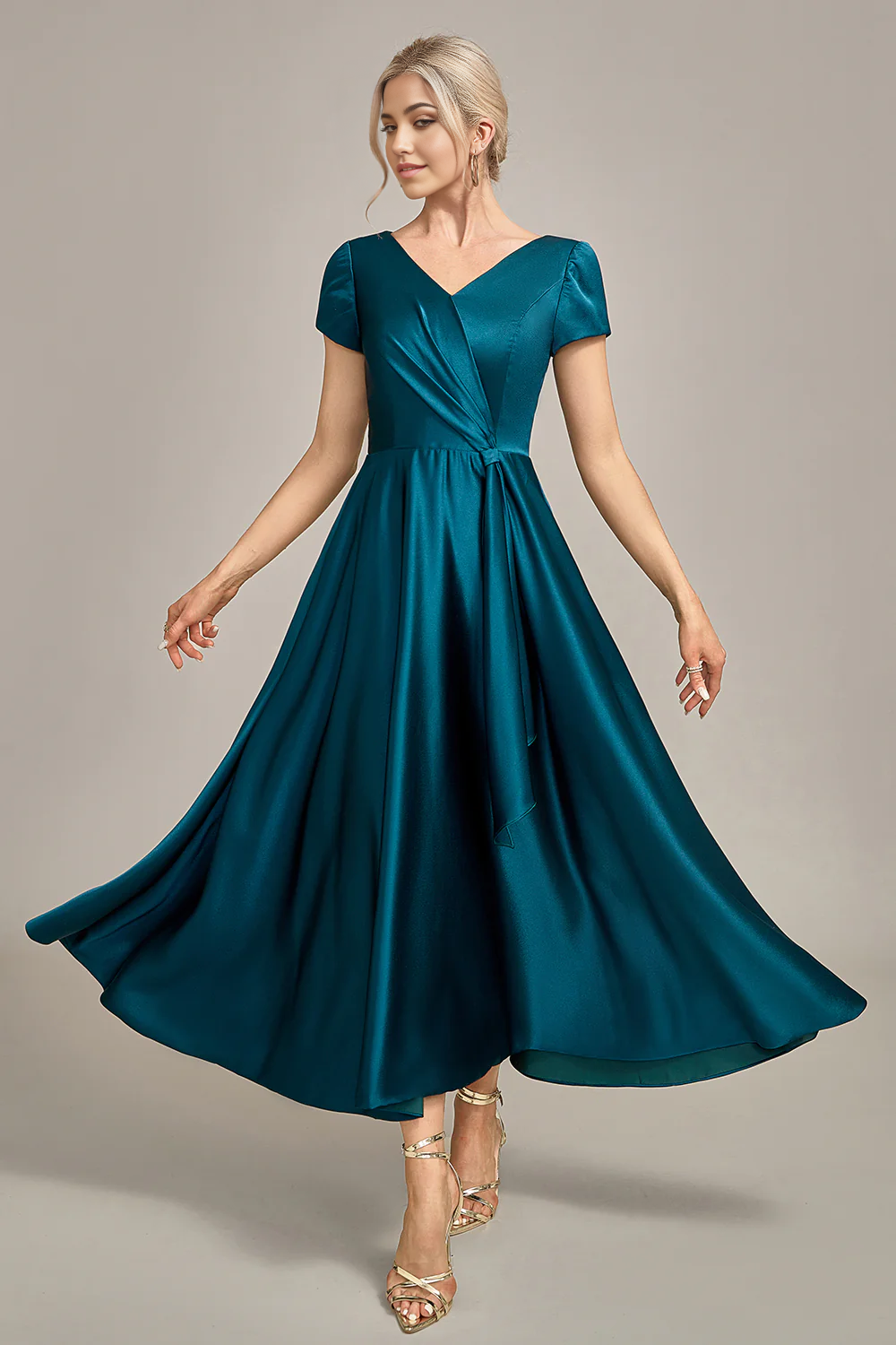 Side profile of the peacock blue A-line V-neck pleated satin dress.