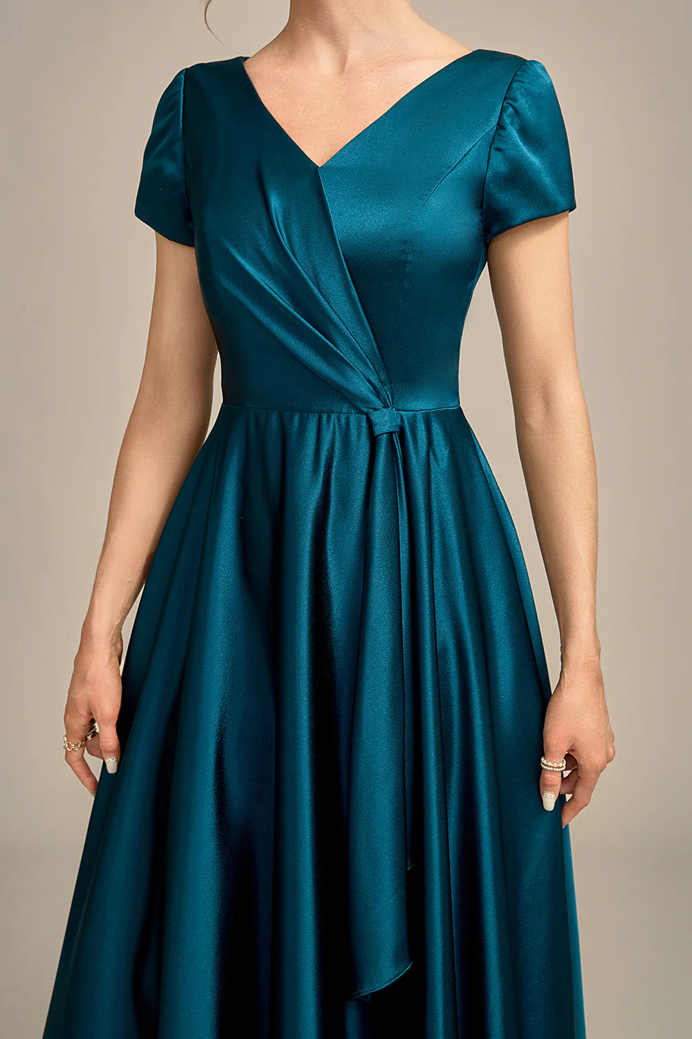 Full length view of the peacock blue A-line V-neck pleated satin dress.