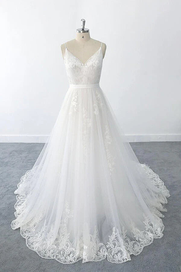 Full view of an elegant A-line V-neck tulle wedding dress with ruffle appliques.