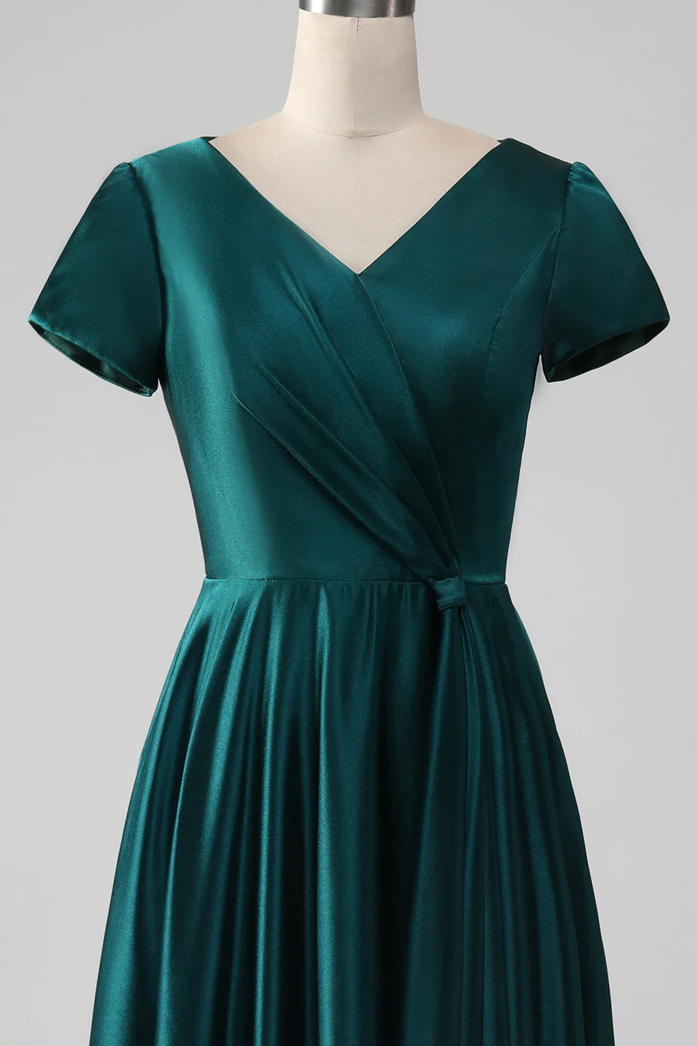 Close-up of the satin fabric and V-neckline of the dress.