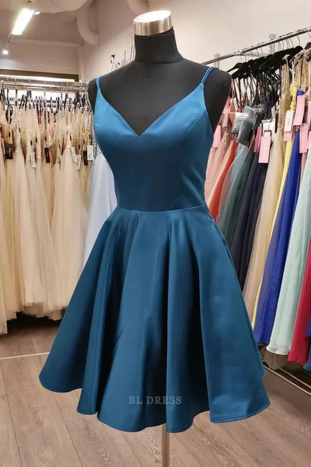 Woman wearing a blue A-line V-neck spaghetti strap long formal dress.