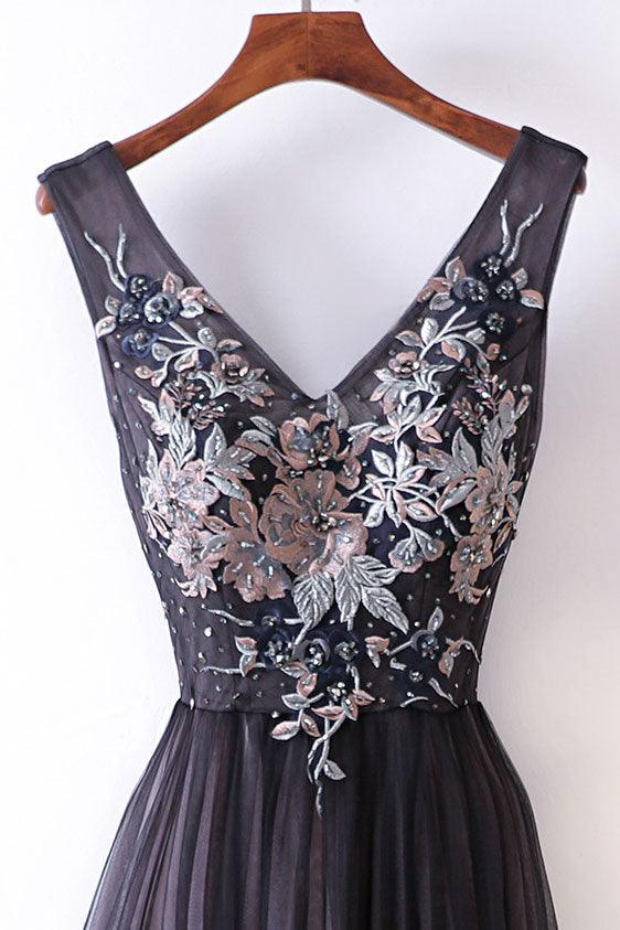 Side view of a woman wearing an A-line V-neck spaghetti strap prom dress.