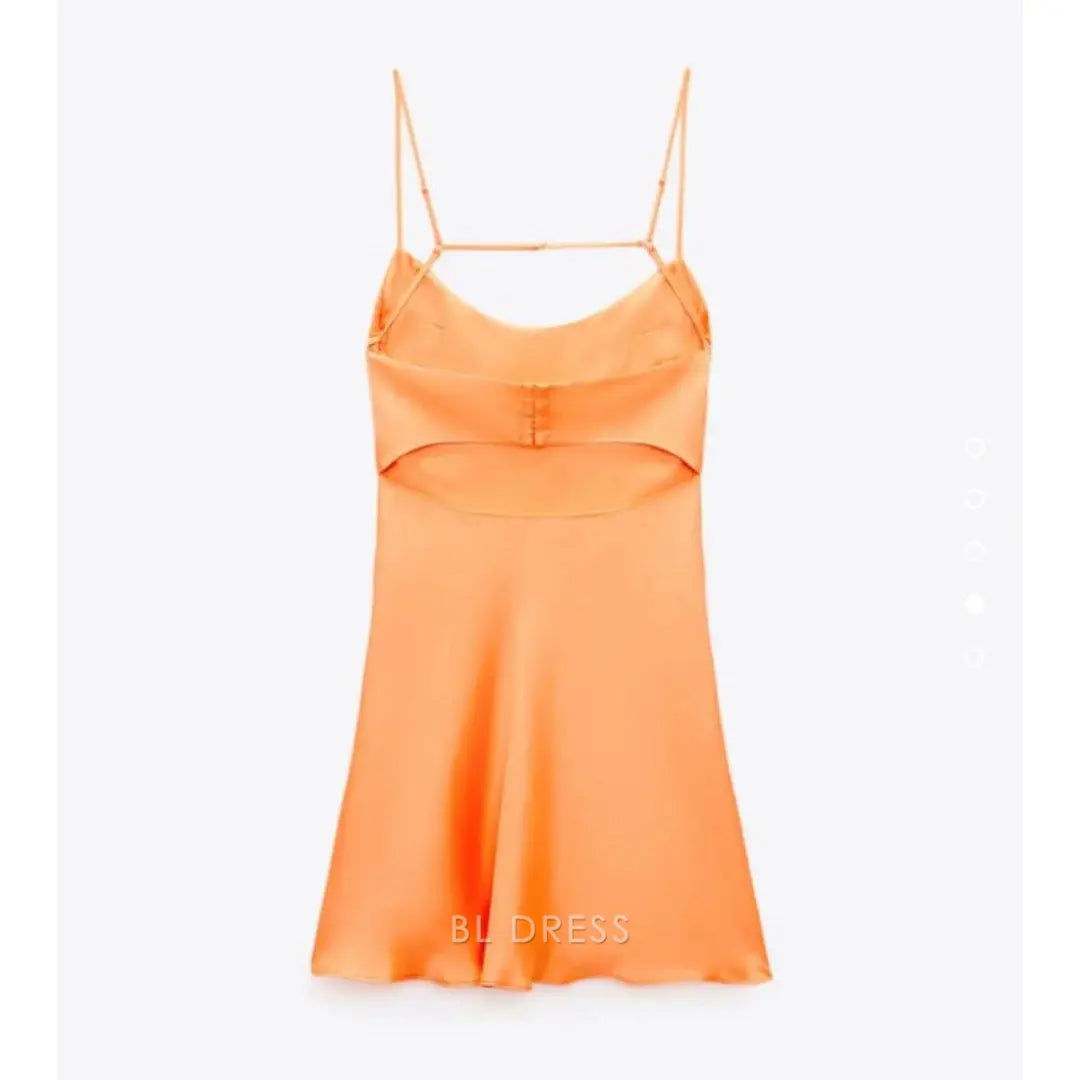 Close-up of the V-neckline and spaghetti straps on the orange formal dress.