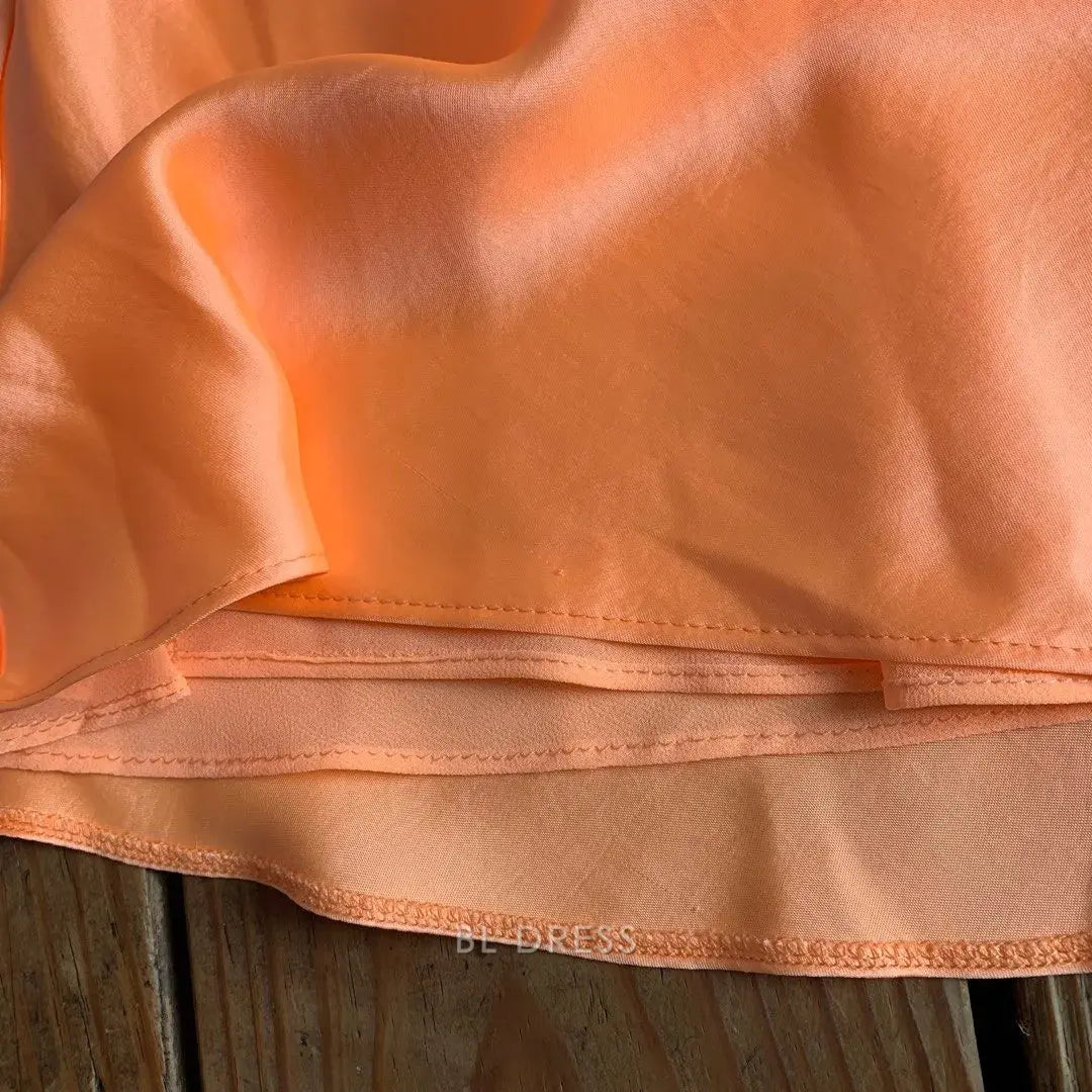 Back view of the orange A-line gown, showcasing its elegant silhouette.