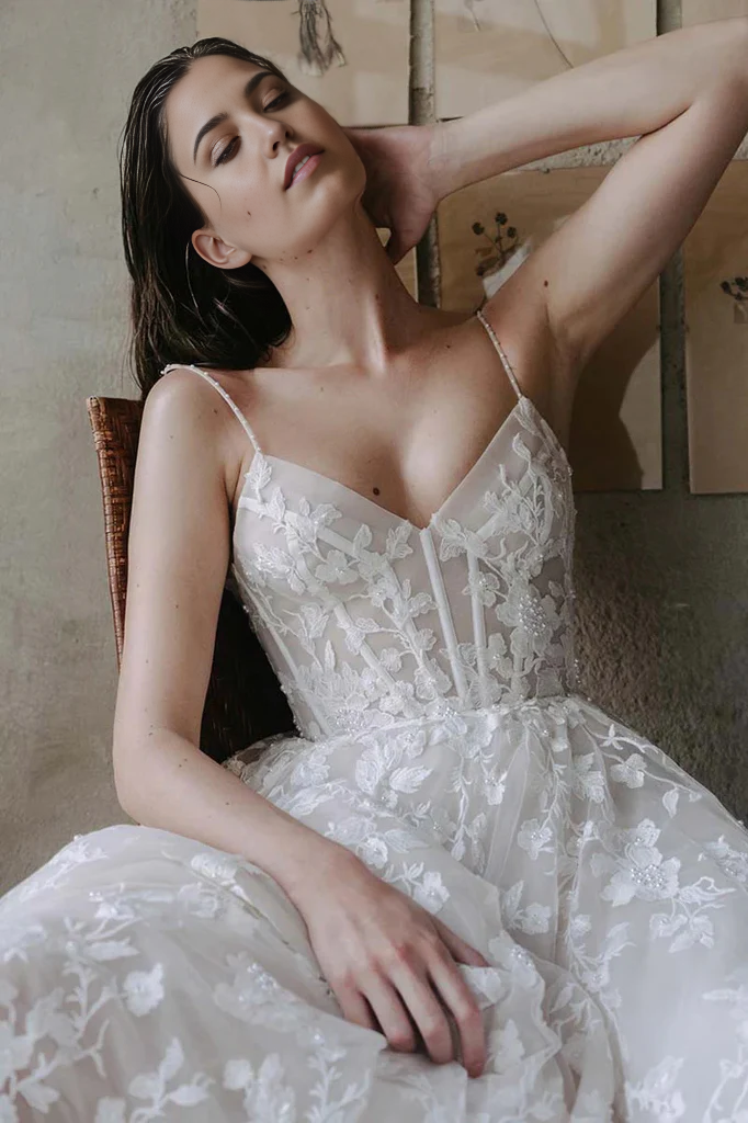 Close-up of lace appliques on a V-neck A-line wedding gown.
