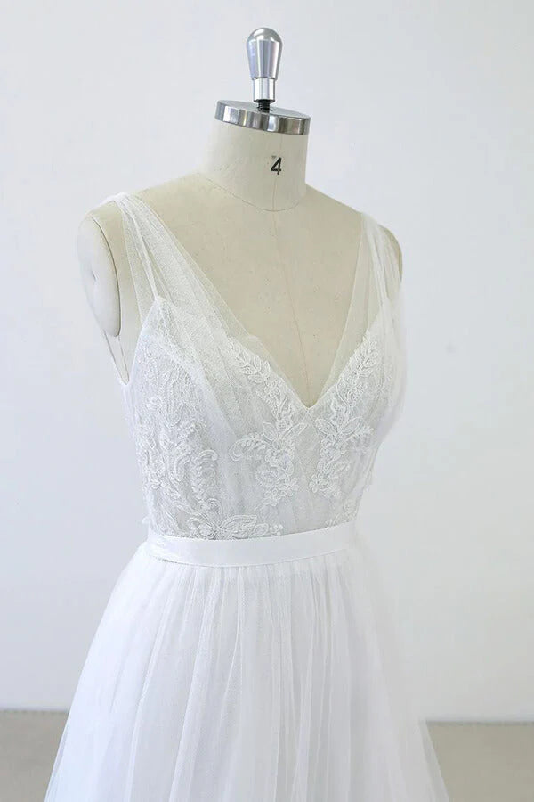 Close-up of ruffle appliques and delicate tulle fabric on a wedding dress.