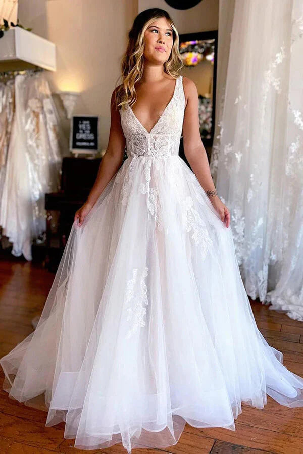 Elegant A-line tulle wedding dress with V-neck and lace appliques.