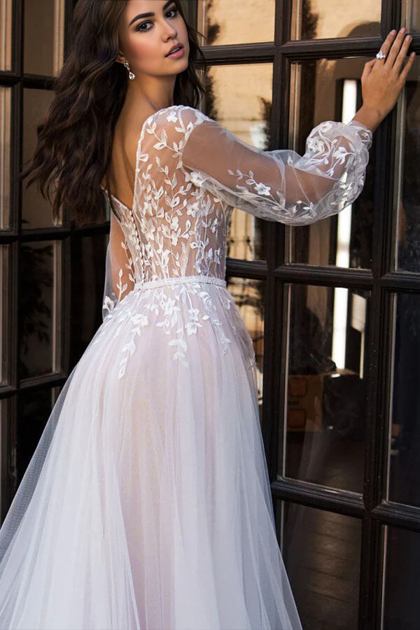 Side profile of A-line tulle and lace wedding dress with long sleeves.