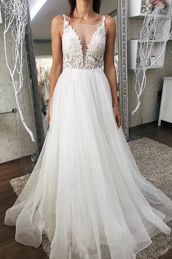Elegant A-line V-neck tulle wedding dress with lace appliques.