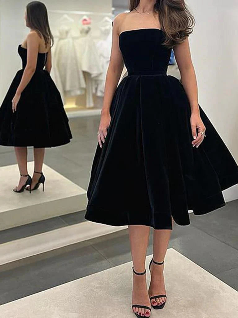 Model wearing an elegant A-line V-neck velvet tea length prom dress.