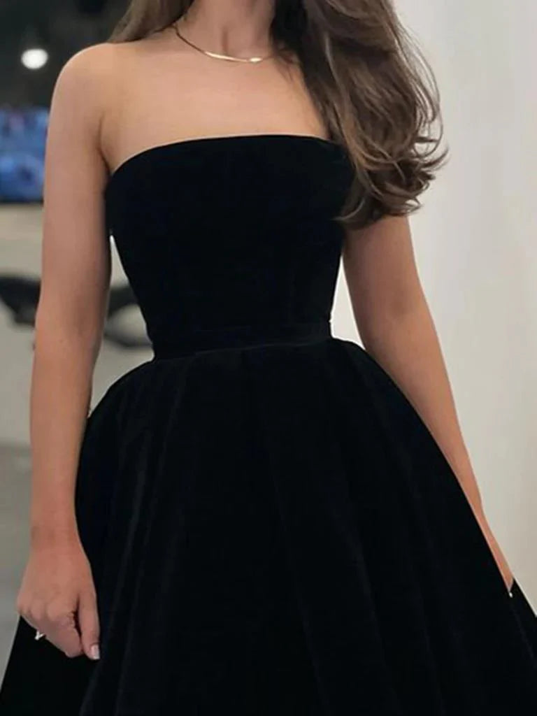 Close-up of the velvet fabric and V-neckline on an A-line tea length prom dress.