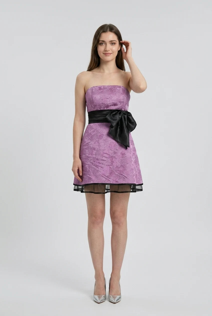 Model in a light-colored V-neck A-line dress with spaghetti straps, full length.