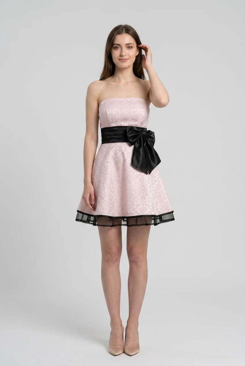 Model in a light-colored V-neck A-line dress with spaghetti straps, side profile.