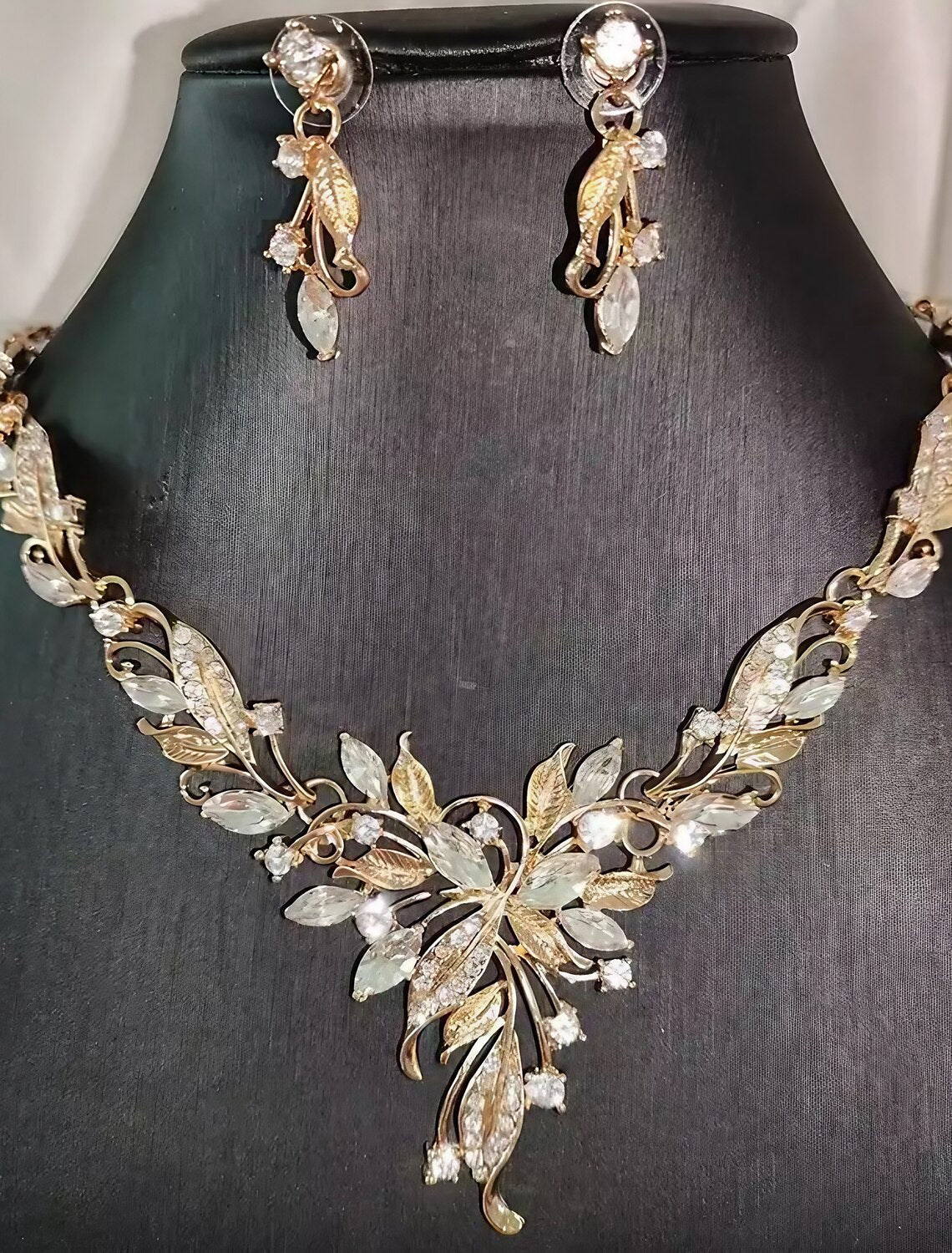 Woman wearing an elegant alloy necklace and matching earrings set.