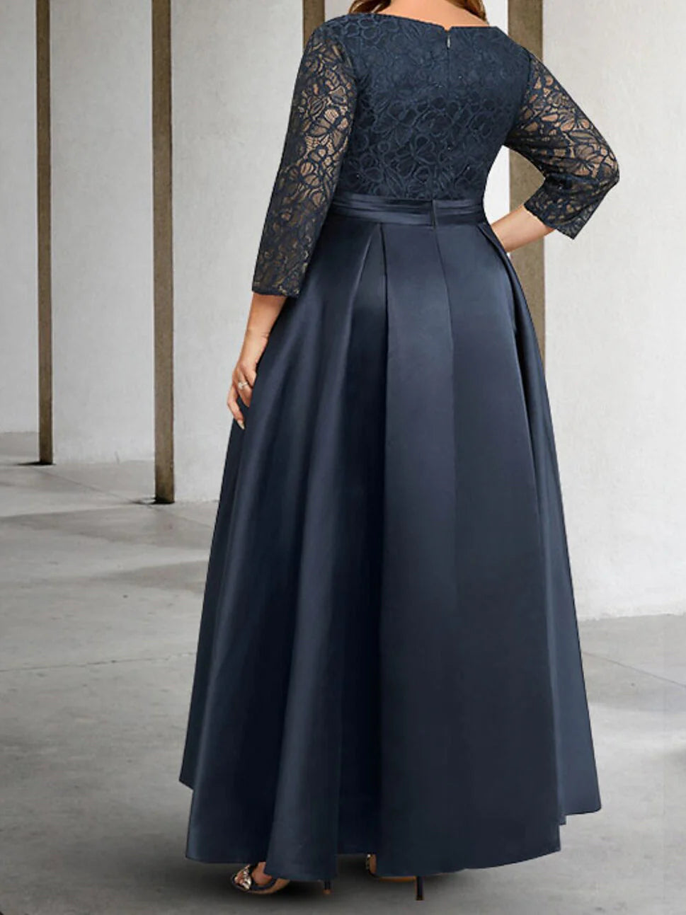 Side view of an A-line applique long sleeve formal gown.