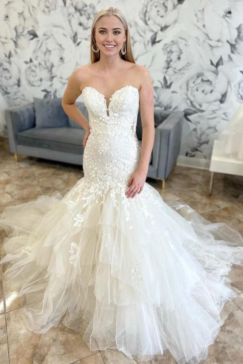 Elegant strapless mermaid trumpet wedding dress with appliques.