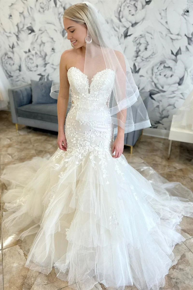 Close-up of appliques on a long mermaid wedding dress.