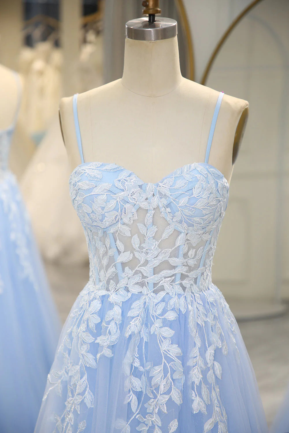 Side profile of the long appliqued prom dress, highlighting the corset bodice and flowing skirt.
