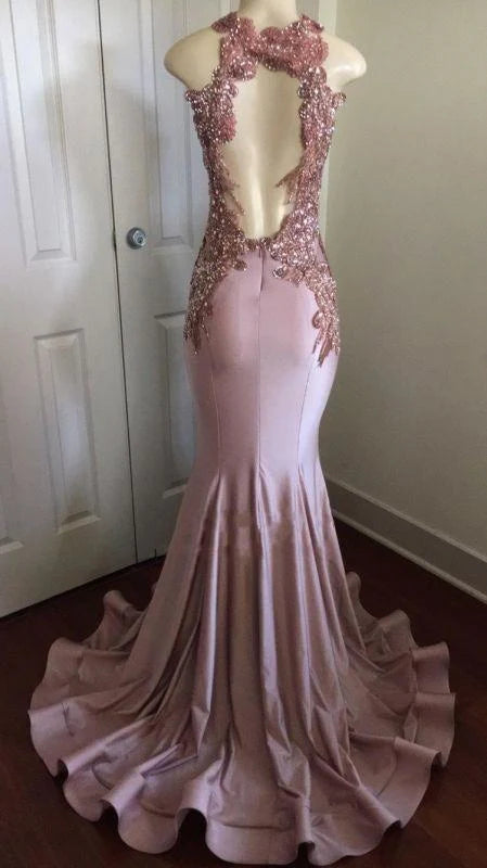Close-up back view of an elegant mermaid prom dress showing open back design and appliques.