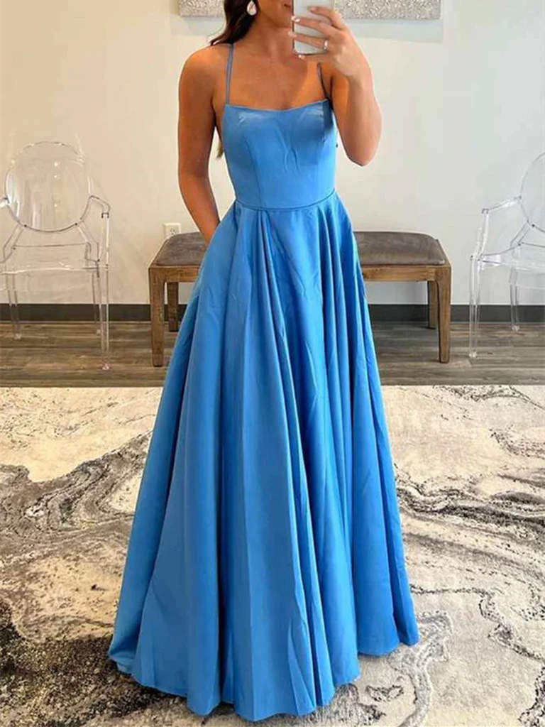 Woman wearing an elegant backless A-line satin prom dress with a V-neckline.