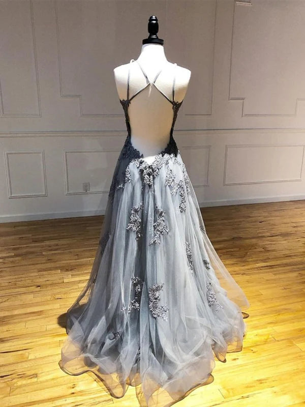 Close-up of backless design and lace appliques on formal gown.