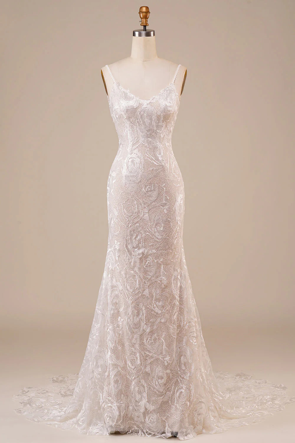 Model wearing an ivory backless lace mermaid wedding dress with a sweep train.