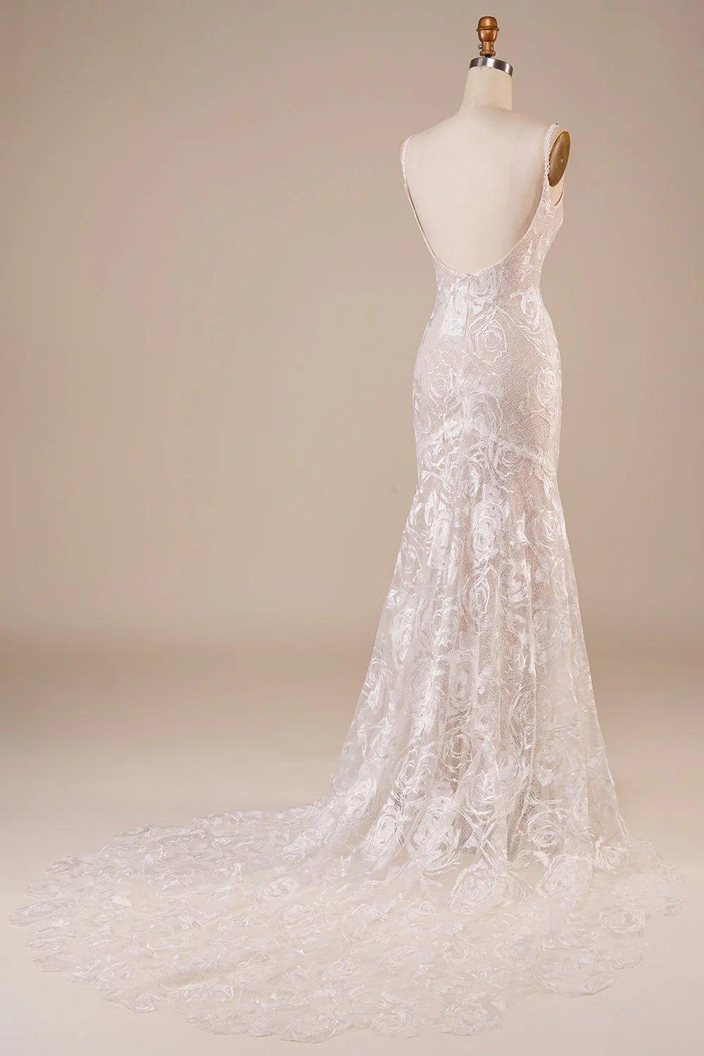 Close-up of the delicate lace detail on the backless wedding dress.