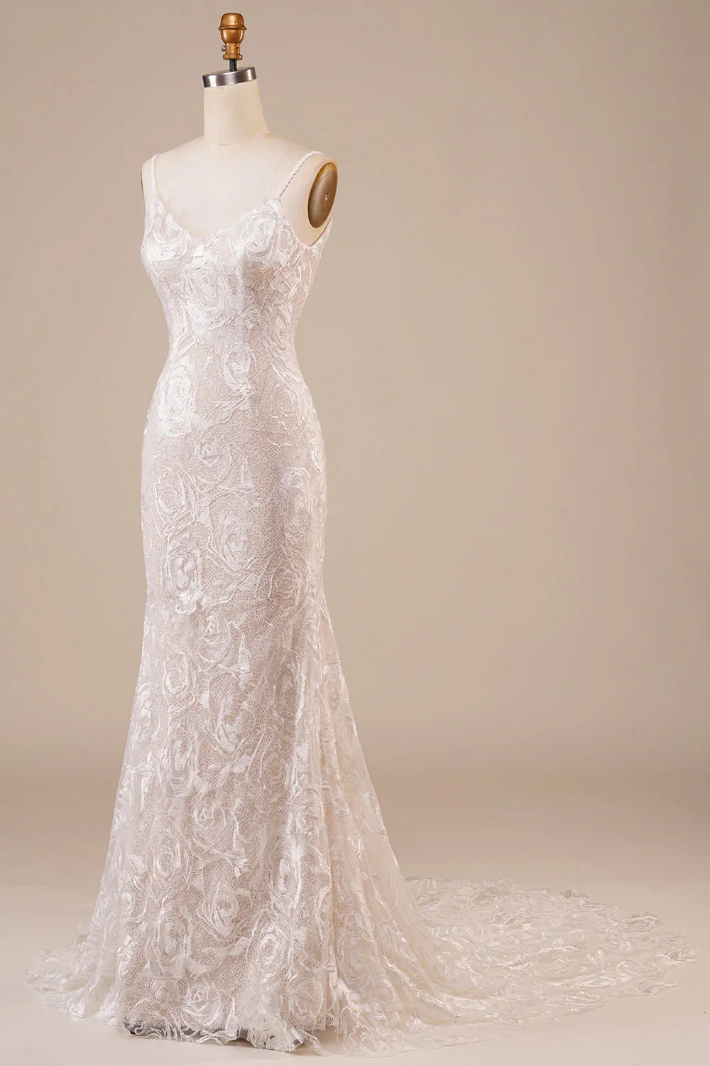 Full view of the backless lace bridal gown, highlighting the elegant train.