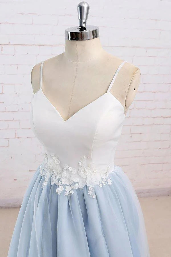 Side view of a spaghetti strap tulle gown, highlighting the sweep train.