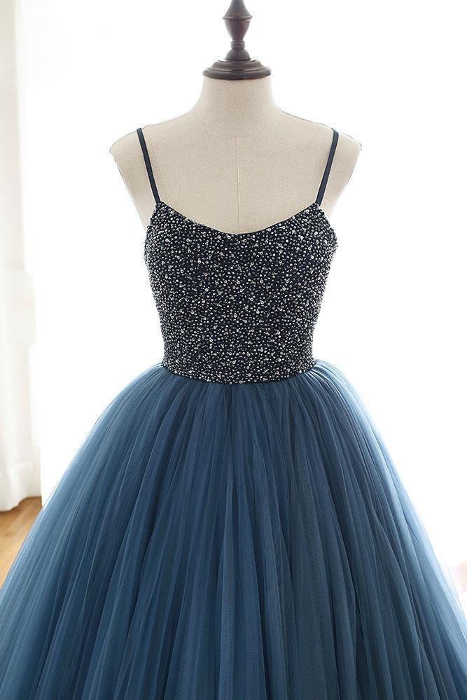 Close-up of the beaded bodice and deep V-neckline of a tulle ball gown.