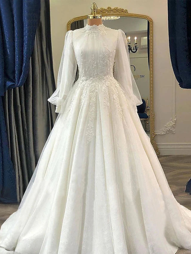 Elegant vintage ball gown wedding dress with high neck and long lace sleeves.