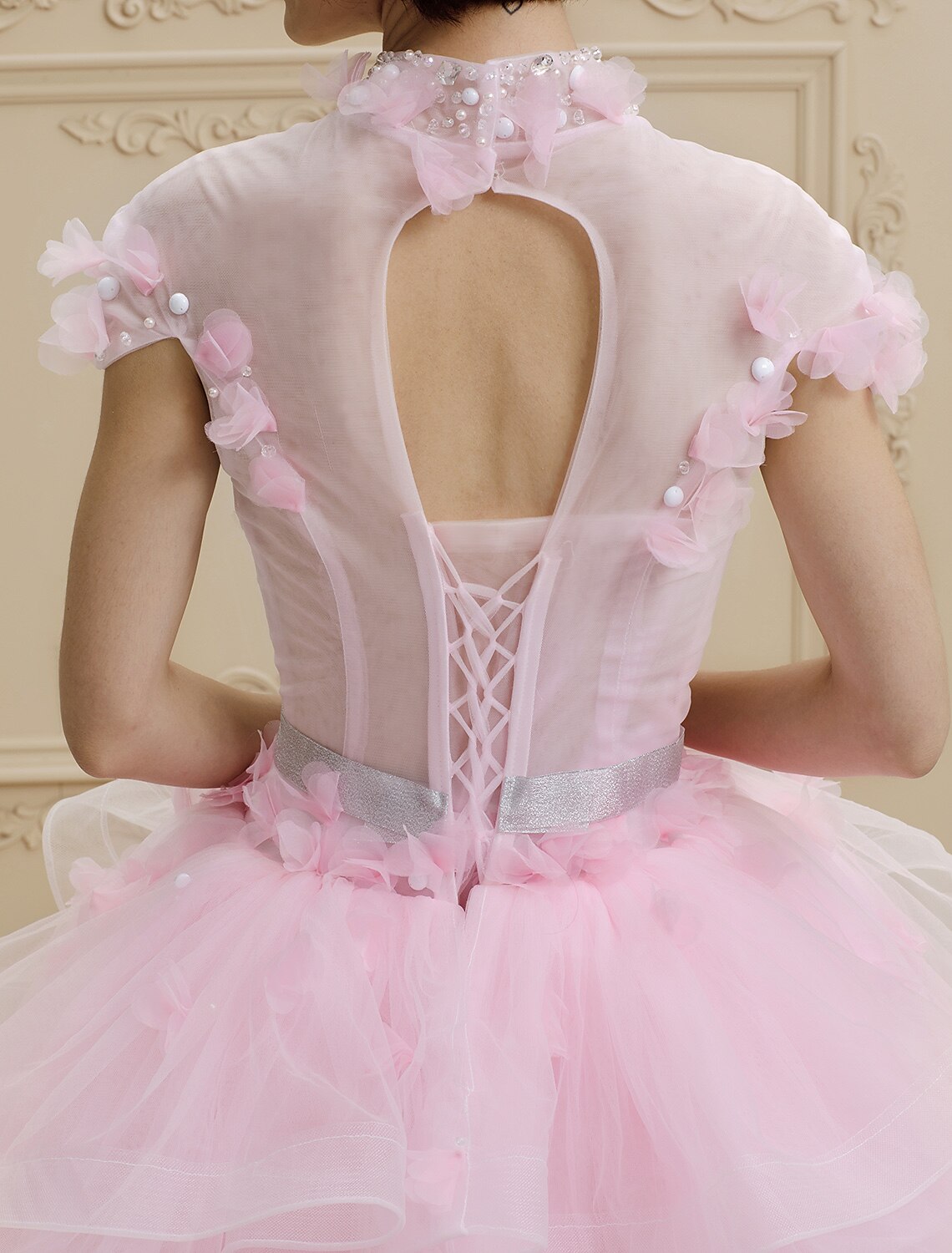 Side view of floor-length organza tulle wedding gown.