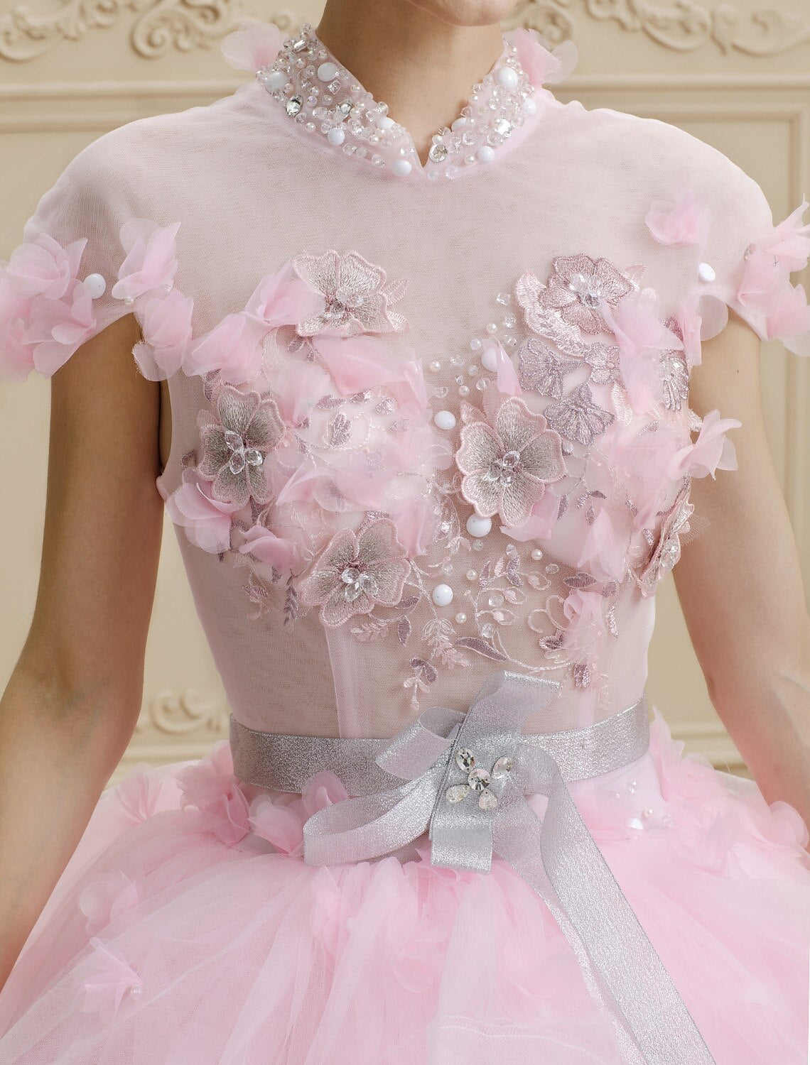 Close-up of crystal beading and flower embellishments on wedding dress.