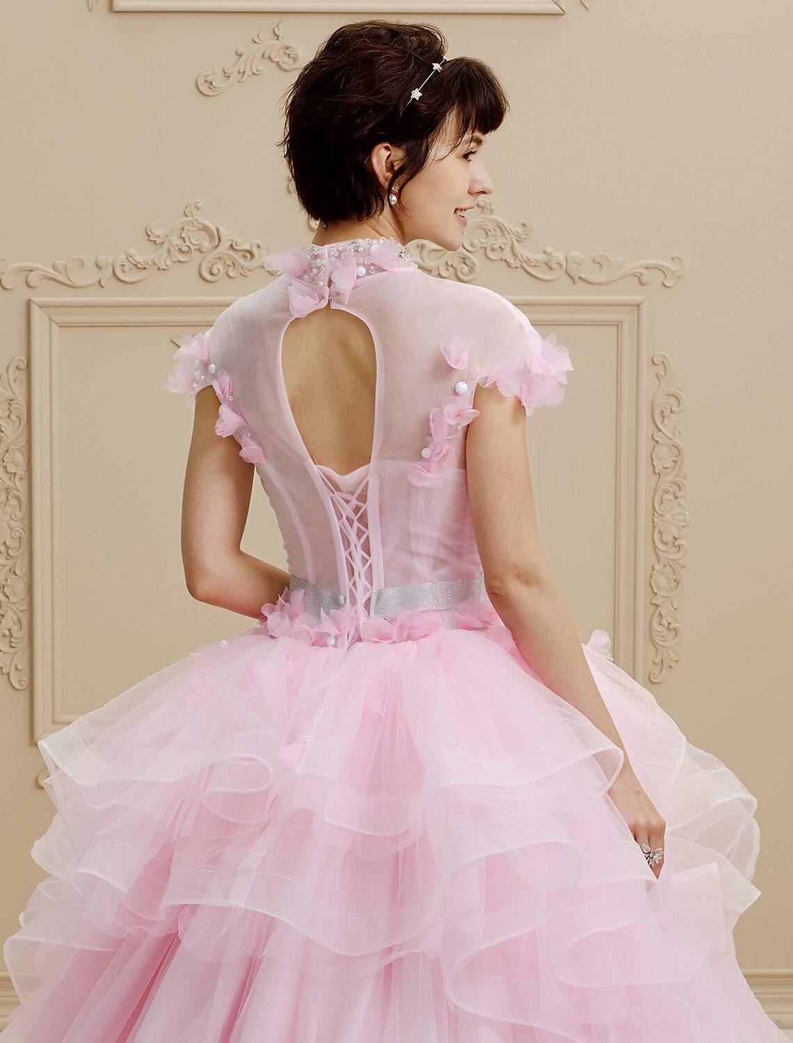Model posing in elegant high neck bridal gown.