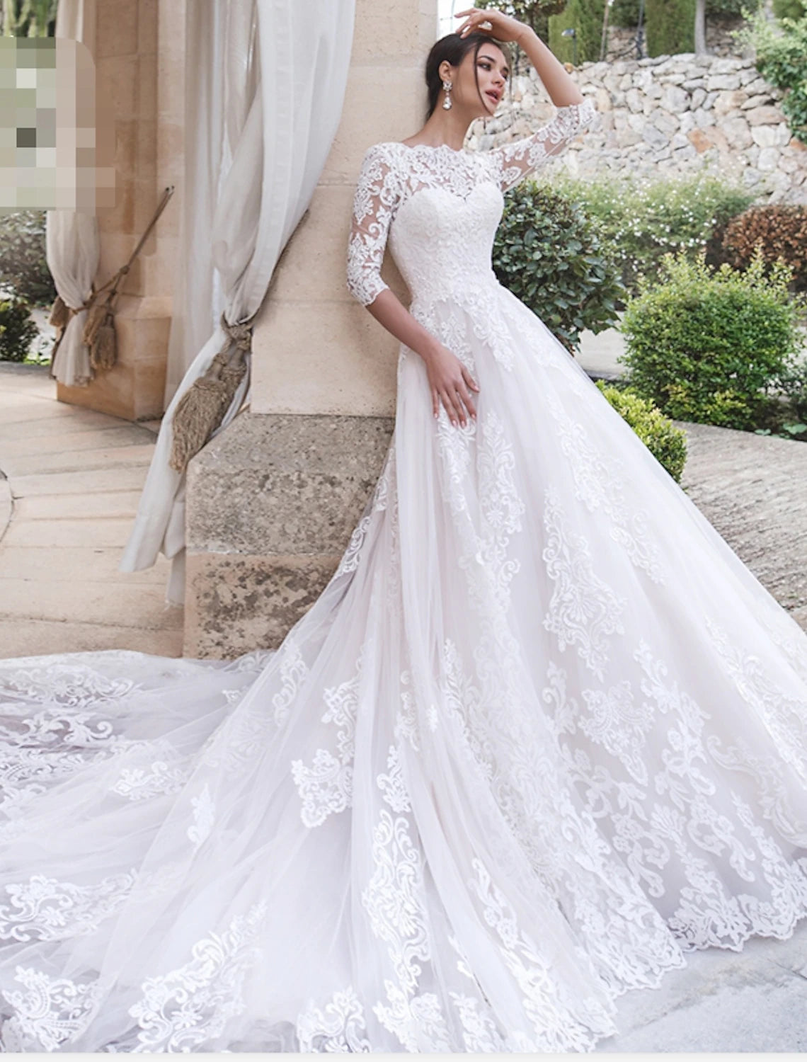 Elegant ball gown wedding dress with illusion neck, lace, and 3/4 sleeves.